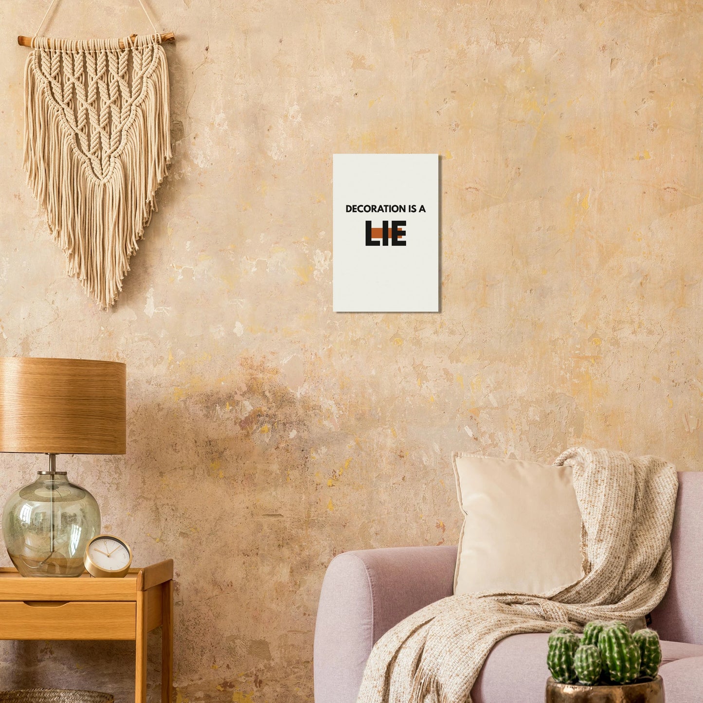 Decoration Is a Lie typography poster on a warm textured wall with lamp and armchair