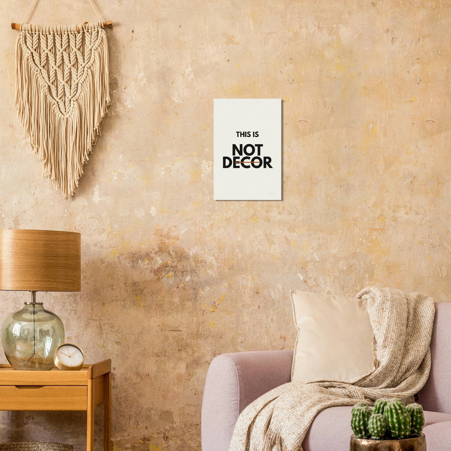 This Is Not Decor typography poster on a warm textured wall with lamp and armchair