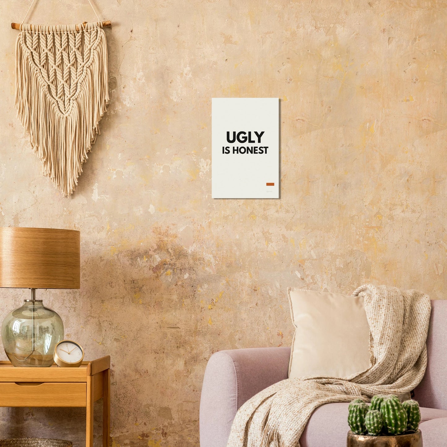 Ugly Is Honest typography poster on a warm textured wall with lamp and armchair
