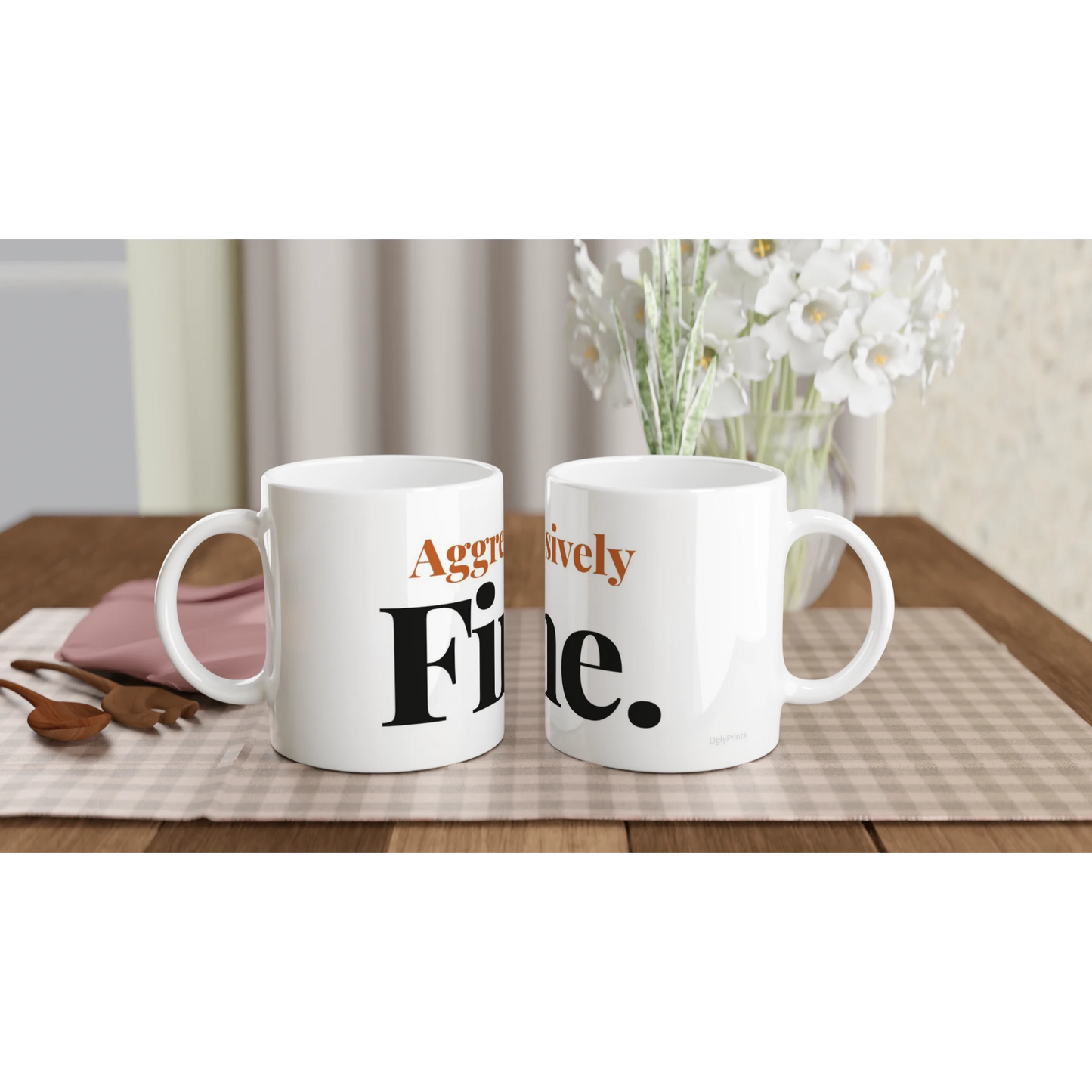 Aggressively Fine funny typography mugs on table with flowers lifestyle setting