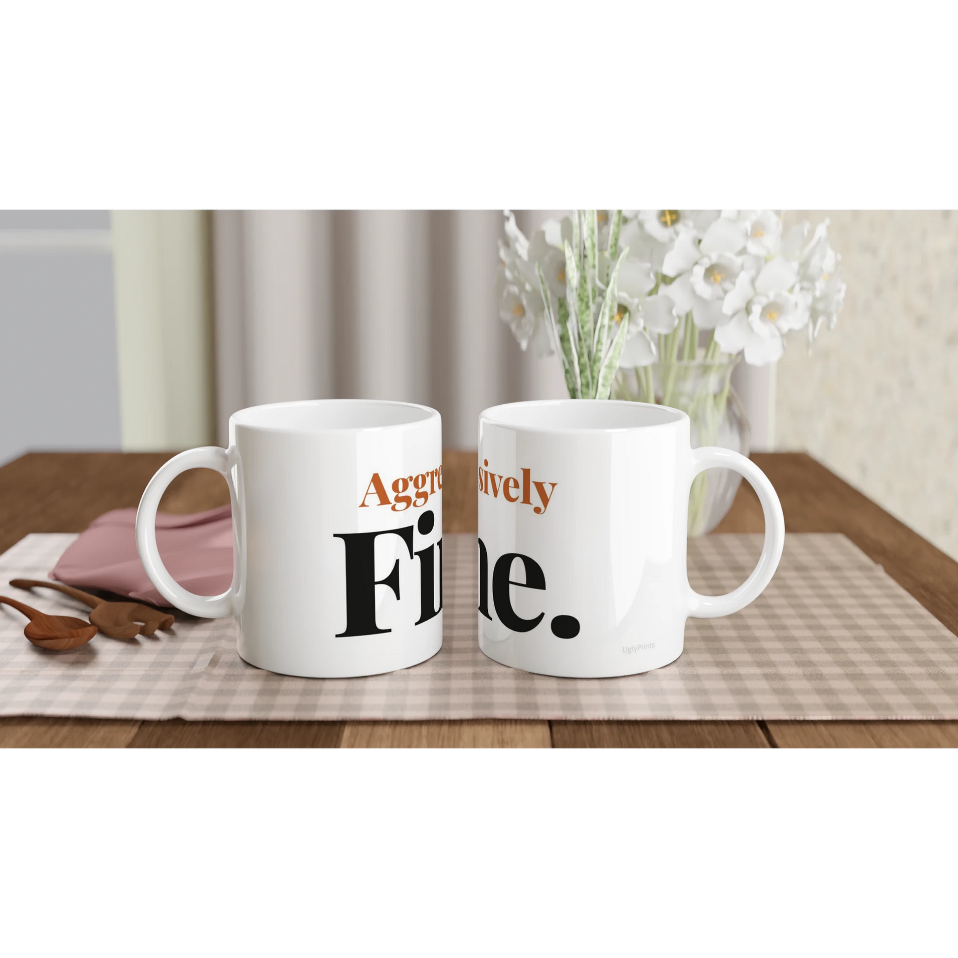 Aggressively Fine funny typography mugs on table with flowers lifestyle setting