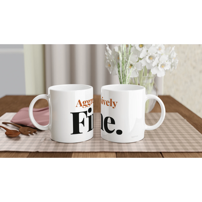 Aggressively Fine funny typography mugs on table with flowers lifestyle setting