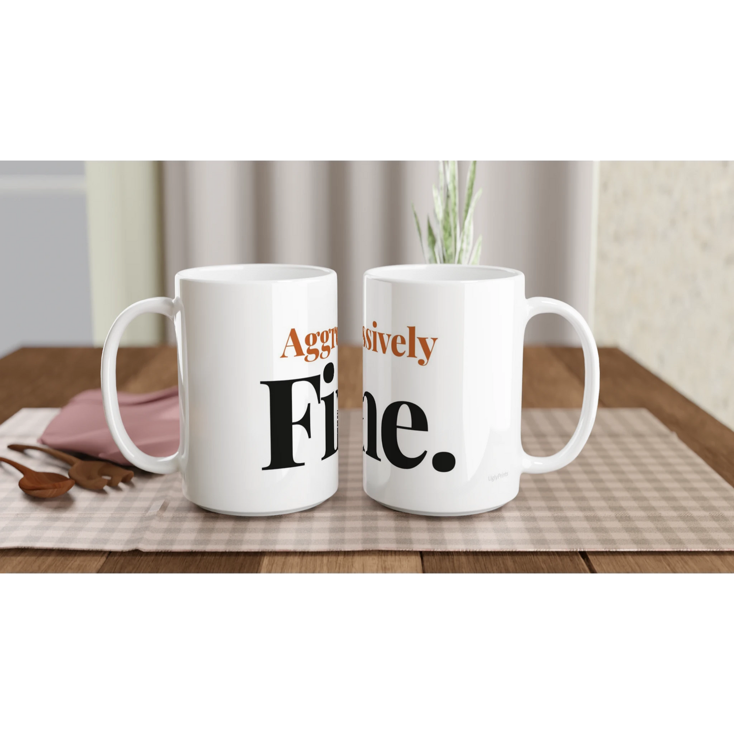Aggressively Fine funny typography mugs on table with flowers lifestyle setting