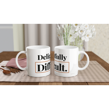Delightfully Difficult funny typography mugs on table with flowers lifestyle setting