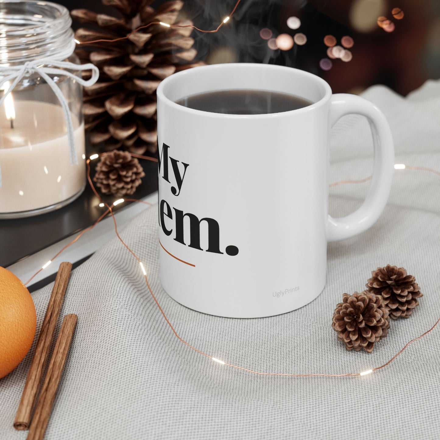 Not My Problem funny office mug styled in a warm cosy setting with pine cones cinnamon and fairy lights