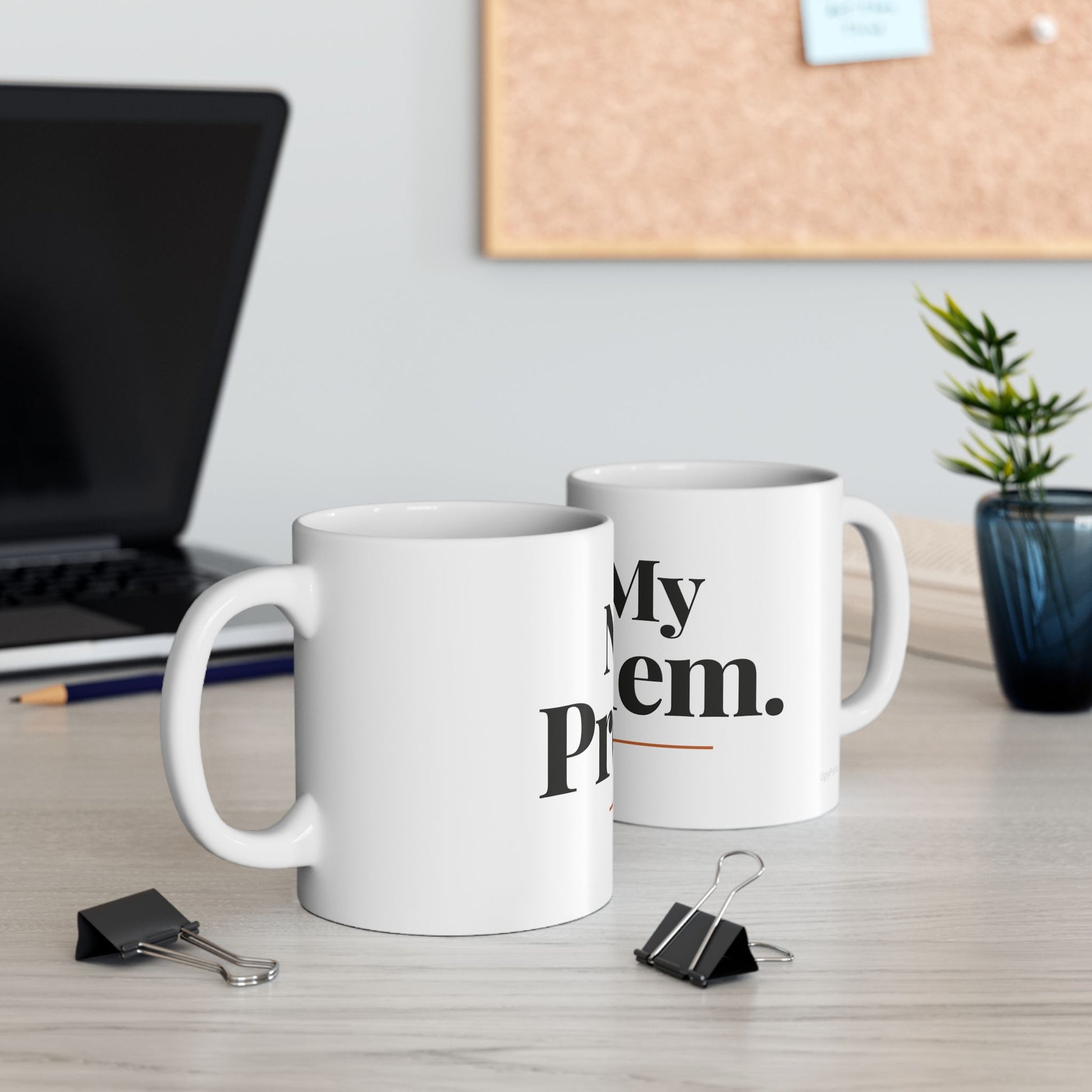 Not My Problem funny typography mugs on a modern office desk with laptop cork board and plant