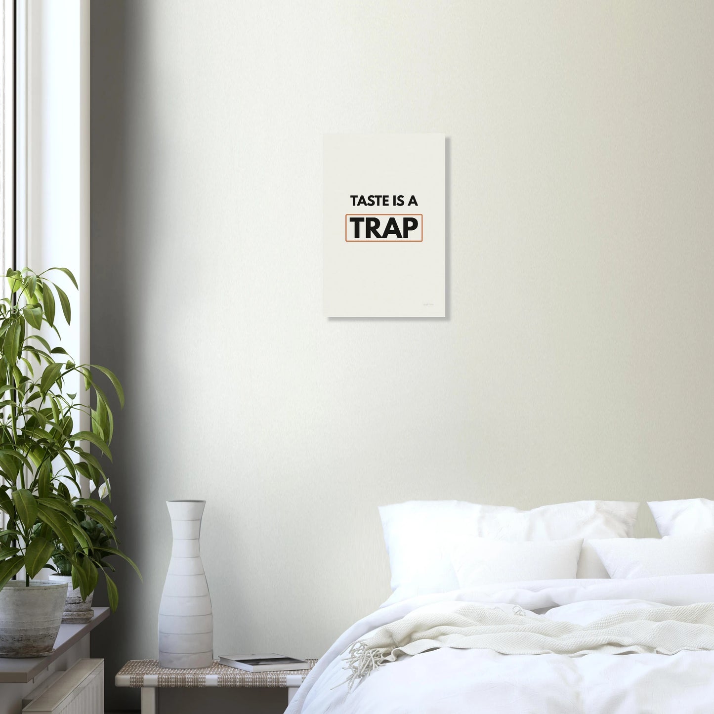 Taste Is a Trap typography wall print in a bright bedroom with white walls and green plant