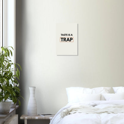 Taste Is a Trap typography wall print in a bright bedroom with white walls and green plant