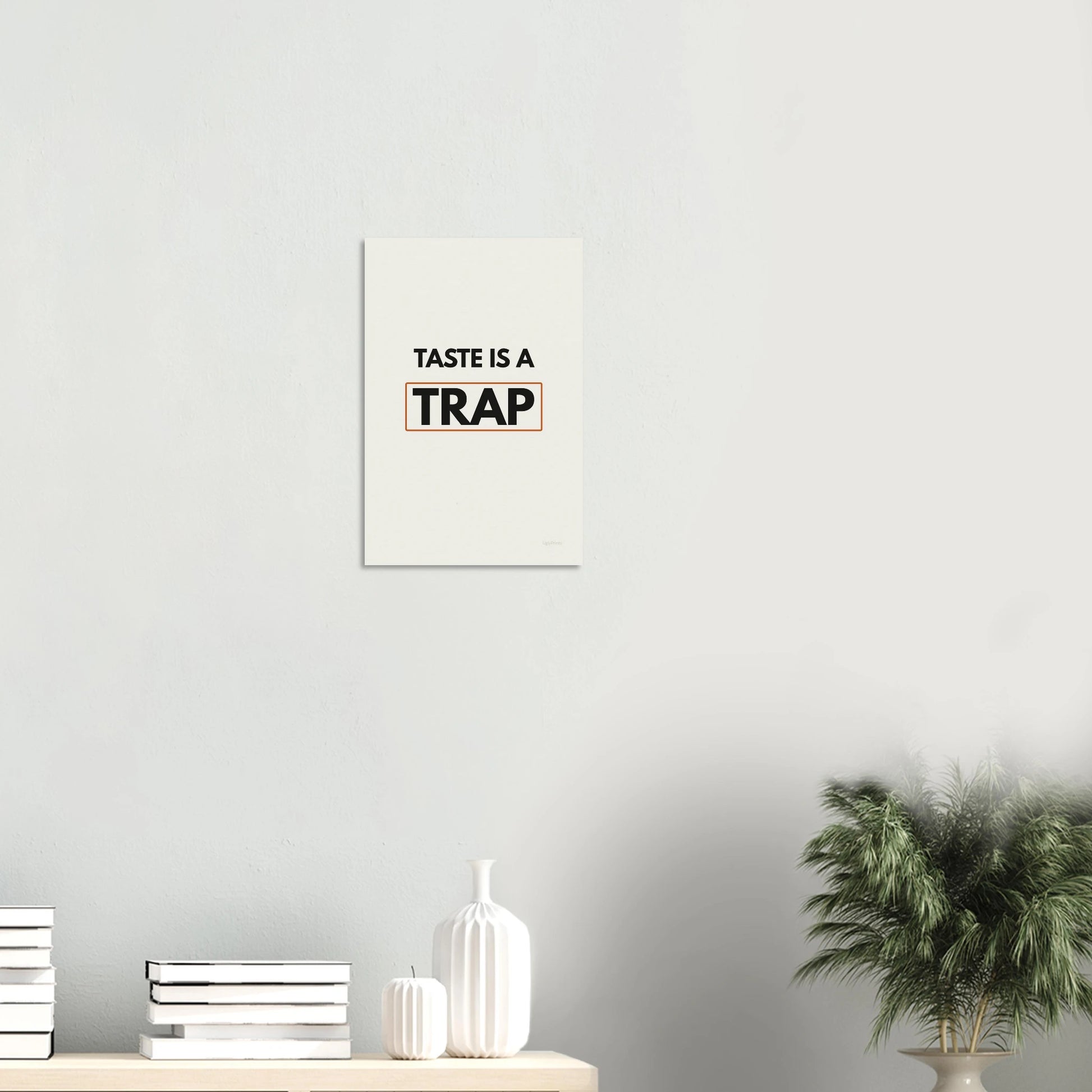 Taste Is a Trap typography poster in a minimal white room with shelf and plants