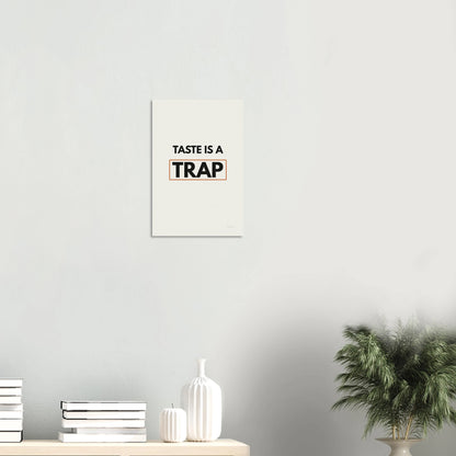 Taste Is a Trap typography poster in a minimal white room with shelf and plants