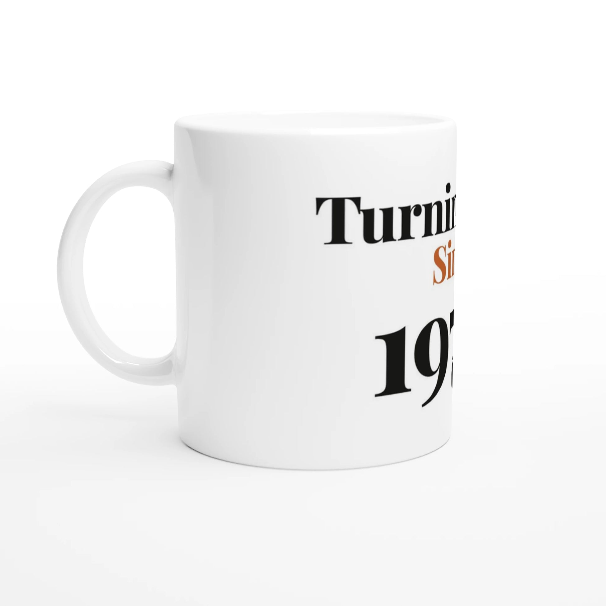 Turning Fine Since 1976 — 11oz white ceramic funny birthday mug angled side view