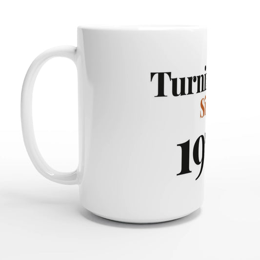 Turning Fine Since 1976 — 15oz white ceramic funny birthday mug angled side view