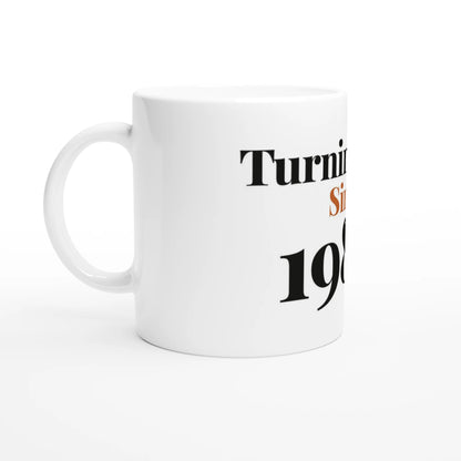 Turning Fine Since 1986 — 11oz white ceramic funny birthday mug angled side view
