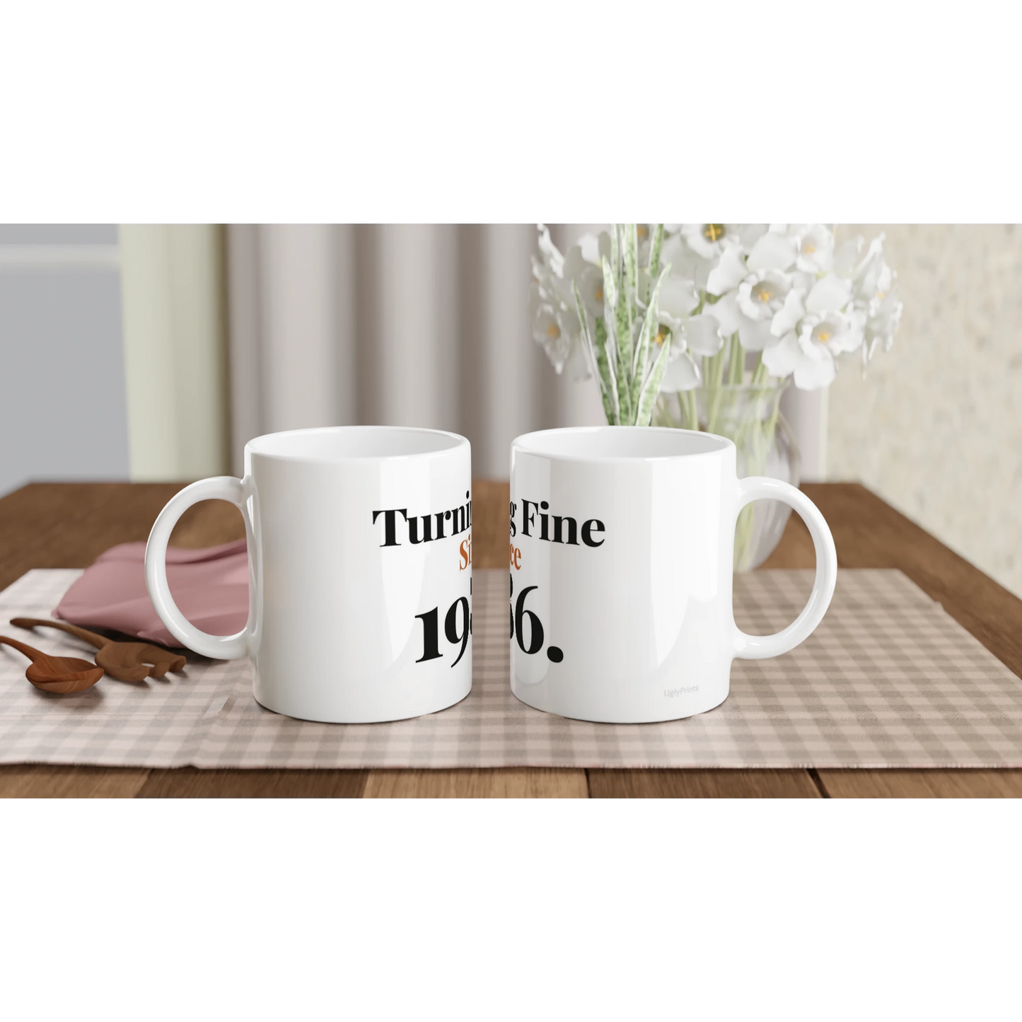 Turning Fine Since 1986 funny birthday mugs on table with flowers lifestyle setting