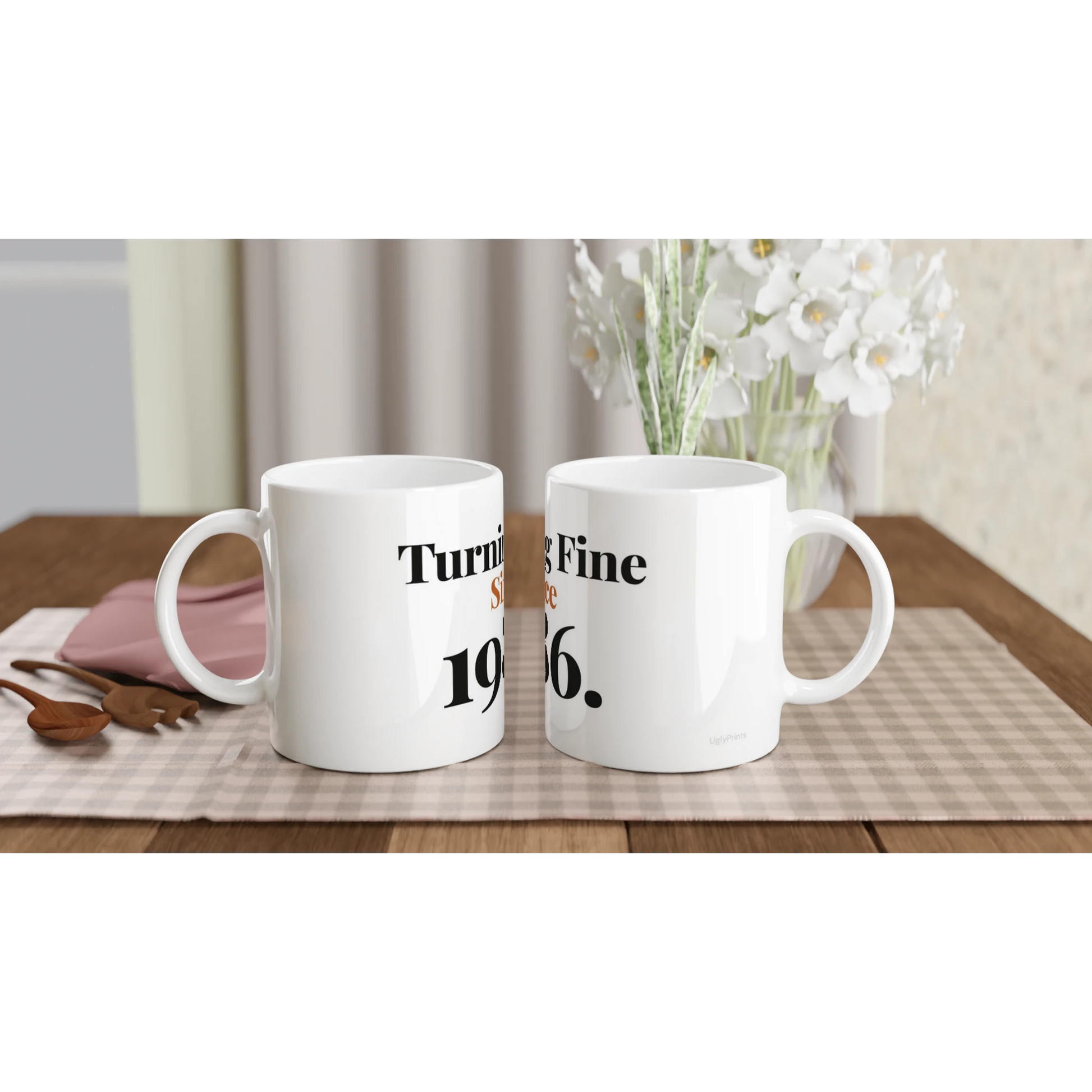 Turning Fine Since 1986 funny birthday mugs on table with flowers lifestyle setting