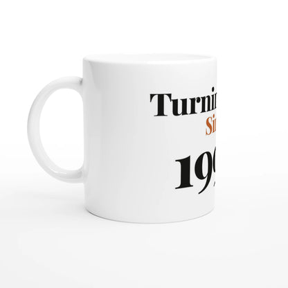 Turning Fine Since 1996 — 11oz white ceramic funny birthday mug angled side view