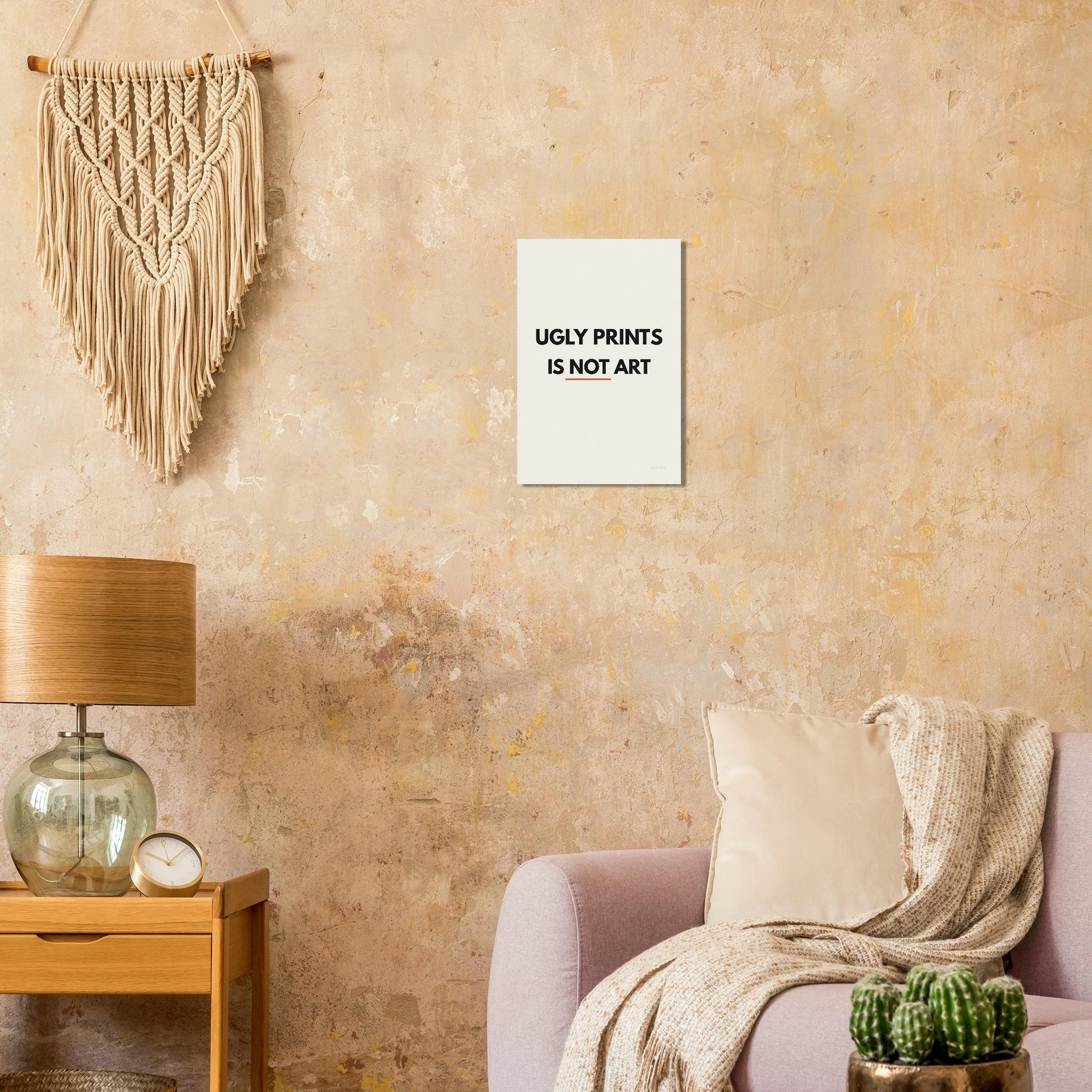 Ugly Prints Is Not Art typography poster on a warm textured wall with lamp and armchair