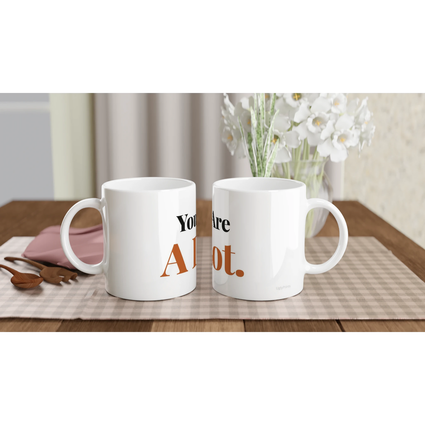 You Are A Lot funny typography mugs on table with flowers lifestyle setting