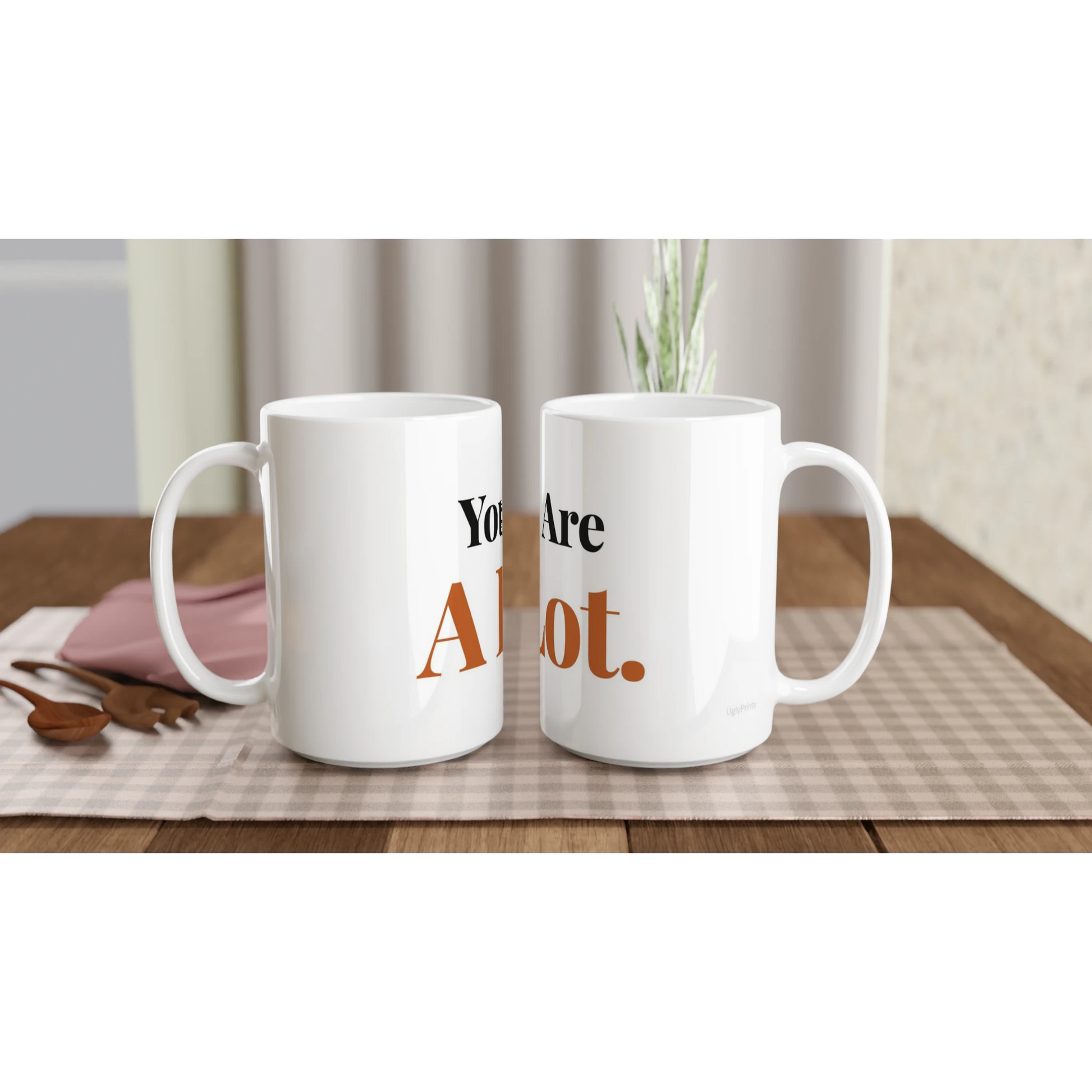 You Are A Lot funny typography mugs on table with flowers lifestyle setting