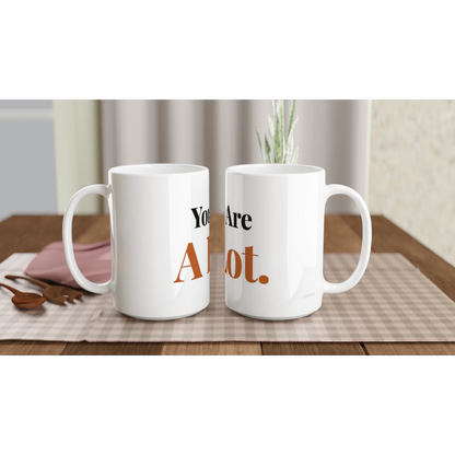 You Are A Lot funny typography mugs on table with flowers lifestyle setting